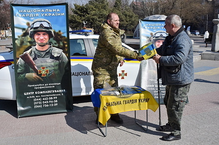A serviceman shake hands with a veteran by the recruitment point of the National Guard of Ukraine in Zaporizhzhia. As Ukraine enters its third year of war, victory against Russia seems an increasingly distant prospect. Last summer’s failed counteroffensive, combined with stalled Western aid, has put the Ukrainian military on the defensive. The need to rotate exhausted troops out of fighting is running up against a growing manpower shortage. Ukraine’s armed forces need more fighters: The country’s General Staff requested 500,000 additional men be mobilized to supplement the already 1.1 million-strong military, President Volodymyr Zelensky said during a press conference on Dec. 19 (2023).