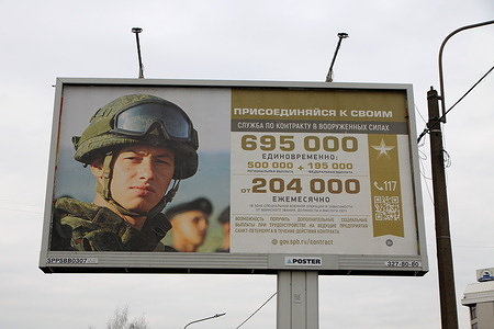 A billboard recruiting individuals interested in joining the Armed Forces of the Russian Federation for a special operation in Ukraine is seen on a street in St. Petersburg.
