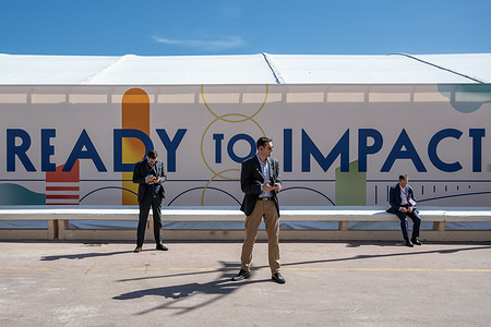 Three businessmen are seen in front of the "ready to impact" sign at Mipim in Cannes. The MIPIM Fair in Cannes, southern France, is considered to one of the world's largest real estate exhibitions. The event highlights real estate from around the globe and pledges "to be a pioneering event in matters of sustainability". More than 22,000 delegates are expected to attend from 90 countries.