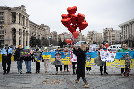 Family members of Ukrainian prisoners of war hold signs during a rally of relatives of Ukrainian prisoners of war demanding that the authorities release their relatives from Russian captivity, in central Kyiv.