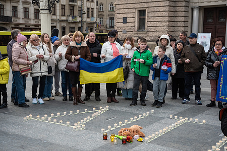 People with candles in their hands stand near the inscription "CHILDREN" during the commemoration event. Lviv residents and forcibly displaced residents of occupied Mariupol attend an event commemorating those who died 2 years ago at the Mariupol Drama Theatre, near the Solomiya Krushelnytska Lviv National Academic Theater of Opera and Ballet. Residents of Mariupol gathered near the theatres of Lviv and many cities of Ukraine and lit memorial lamps to commemorate those who lost their lives. On March 16, 2022, the Russian occupiers dropped aerial bombs on the theatres in Mariupol, ignoring the inscription in capital letters "CHILDREN" in front of the building. At that time, hundreds of civilians, mostly women and children, were hiding in the theatre. The exact number of dead is still unknown, various studies call the number from 300 to 600 people