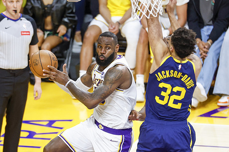 Los Angeles Lakers' LeBron James (L) looks to pass while defended by Golden State Warriors' Trayce Jackson-Davis (R) during an NBA basketball game at Crypto.com Arena, Saturday March 16, 2024, in Los Angeles. Final Score: Warriors 128: 121 Lakers