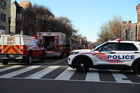 Police block off roads, Sunday afternoon at the scene of a fire in Washington, DC. Working fire on the 1300 block of 14th St Northwest in Washington, DC, United States on March 17, 2024. Fire was at a first floor kitchen restaurant and three story building, the fire on the first floor was knocked down. Fire extended via the ductwork to the roof. Visible fire was extinguished and the incident was brought under control. Five adults living on floors above the restaurant were displaced and the red cross was dispatched to provide assistance.
