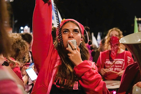 A protester chants slogans megaphone during a demonstration. Two protests merge outside the Kirya military headquarters in Tel Aviv. One called for immediate elections to oust Netanyahu, and the other called for the release of the hostages still being held by Hamas.