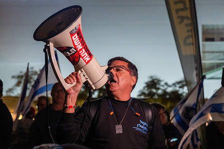 A protester shouts into a megaphone during a demonstration. Thousands attend a protest at Habima Square in Tel Aviv demanding Ultra-Orthodox Jews be included in the compulsory military draft, from which they are currently exempt.