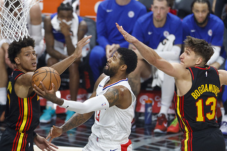 Los Angeles Clippers' Paul George (C) goes to the basket between Atlanta Hawks' Jalen Johnson (L) and Bogdan Bogdanovic (R) during an NBA basketball game at Crypto.com Arena on Sunday, March 17, 2024 in Los Angeles. Final Score: Hawks 110:93 Clippers
