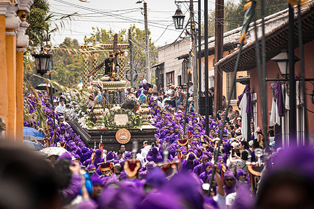 Holy Week procession in Antigua Guatemala, surrounded by hundreds of Catholic faithful. The Celebration of Lent and Holy Week in Guatemala is an Intangible Cultural Heritage of Humanity by UNESCO. The procession of Jesus of the Nazarene of the Fall of San Bartolomé Becerra from the city of Antigua Guatemala goes through the streets surrounded by thousands of parishioners during the fifth Sunday of Lent.