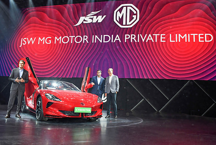L-R Sajjan Jindal, Managing Director (MD) of Jindal Steel, Parth Jindal, Managing Director (MD) of JSW Cement (c) and Rajeev Chaba, CEO Emeritus of MG Motor India pose for a photo with MG Cyberster electric sports car during the launch in Mumbai.