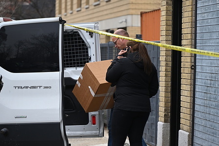 FBI agent carries a box from a warehouse to a van to store it as part of an investigation following a double homicide in Mount Vernon. On the morning of Tuesday, March 19, 2024, an attempted robbery and shooting took place at 137 South 5th Avenue in the City of Mount Vernon, New York. One person died at the scene, and another person passed away at a local hospital. Local police, the NYPD, and the FBI are currently searching for the gunman. Police tapes are cordoning off the scene as the investigation continues throughout the morning on Wednesday to allow the evidence collection process by the FBI to be unimpeded.
