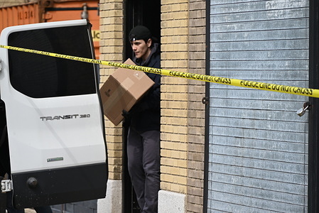 FBI agents load boxes of evidence collected from a warehouse into a storage van following a double homicide in Mount Vernon, New York. On the morning of Tuesday, March 19, 2024, an attempted robbery and shooting took place at 137 South 5th Avenue in the City of Mount Vernon, New York. One person died at the scene, and another person passed away at a local hospital. Local police, the NYPD, and the FBI are currently searching for the gunman. Police tapes are cordoning off the scene as the investigation continues throughout the day on Wednesday. Police tape was set up to allow the evidence collection process by the FBI to be unimpeded.