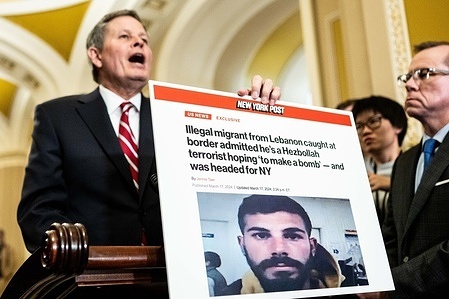 U.S. Senator Steve Daines (R-MT) holding a poster board with a New York Post headline about an "illegal migrant" while speaking at a press conference at the U.S. Capitol.