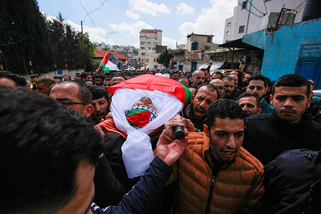 (EDITOR'S NOTE: Image depicts death)
Mourners carry the flag-draped dead body of one of the three men killed in an Israeli air strike. On March 20, an Israeli strike in the occupied West Bank resulted in the deaths of three Palestinians, according to the Palestinian health ministry. The Israeli army stated that it had "eliminated" Ahmed Barakat, who was accused of carrying out an attack in May 2023 that resulted in the death of an Israeli settler.