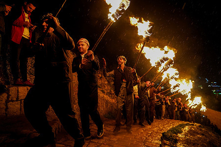 Iraqi Kurds carry fire torches as they celebrate Nowruz Day, a festival marking the first day of spring, Kurdish and Persian New Year. People celebrated Newroz in the town of Akre. Newroz or Nowruz means "new day" in Persian, and is celebrated to mark the arrival of spring and the first day of the Iranian calendar. It is widely celebrated in Persian and neighboring regions and is recognized on UNESCO's Intangible Cultural Heritage of Human List.