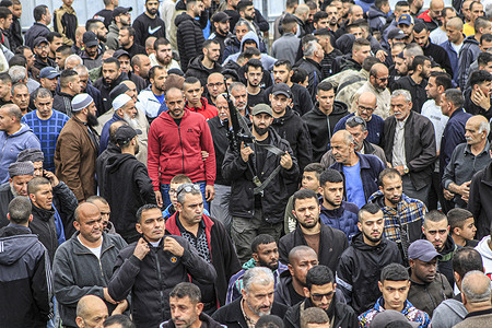 A Palestinian gunman attends a funeral in Tulkarem in the occupied West Bank after four men were killed in an Israeli military operation in the Palestinian refugee camp of Nur Shams, which adjoins the town of Tulkarem.