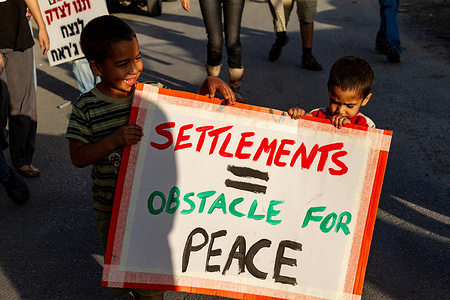 Palestinian children hold a placard expressing their opinion during a demonstration in Sheikh Jarrah.
Sheikh Jarrah is a small Palestinian neighborhood adjacent to Jerusalem Old Town in East Jerusalem. Its inhabitants hold frequent protests against Israeli administrative regulations they see as discriminatory and in favour of settlers.
