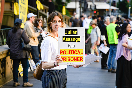 A protester holds a placard with inscriptions "Julian Assange is a political prisoner" during the rally. Protesters gathered outside the Town Hall to urge the Australian government to take action and bring Julian Assange, the Australian journalist who founded WikiLeaks, back to his home country from UK.
