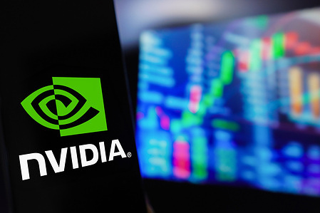 In this photo illustration, the Nvidia Corporation logo is displayed on a smartphone screen, with a graphic representation of the stock market in the background.