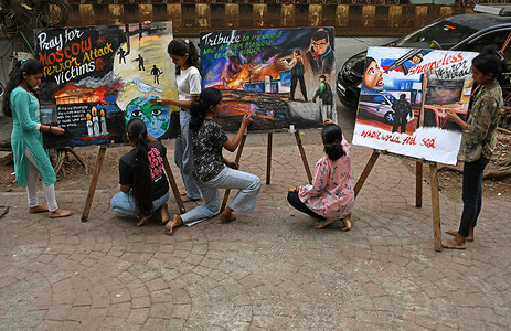 Students from Gurukul school of art paint a poster paying tribute to victims of Moscow terror attack outside their art school in Mumbai. At least 133 people died and more than 100 were injured at the Crocus city hall concert venue near Moscow where the terror attack occurred.