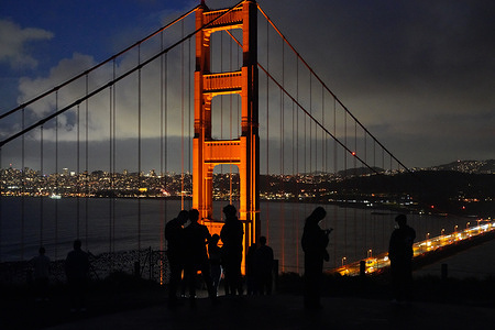 People visit the Golden Gate Bridge at a vista point. Golden Gate Bridge in March 2024.