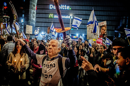 A protestor wears a mask of Israeli Prime Minister Benjamin Netanyahu during a protest. On Saturday, thousands of Israelis held protests across Israel against the current government led by Prime Minister Benjamin Netanyahu and demanded a hostage deal with Hamas.