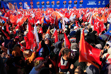 Women wave flags during the Turkish President Recep Tayyip Erdogan’s speech at the Greater Istanbul Restoration rally, which was held at Ataturk Airport ahead of the Turkish local elections.