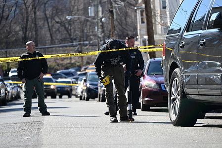 Authorities collect the shell casings and evidence to put them in evidence collection bags. Police investigate a shooting in Paterson. One person was reportedly injured after being shot on 12th Avenue in Paterson, New Jersey Sunday afternoon. Police were seen scouring the area for evidence and marking where shell casings were discovered by placing evidence markers.