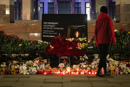 A man stands at a spontaneous memorial to the victims of the terrorist attack at Crocus City Hall, organized near the Russian National Library on Moskovsky Prospekt. Russia mourns the victims of the terrorist attack at Crocus City Hall in Moscow. March 24 became a day of national mourning in the country. People all over Russia bring flowers to spontaneous memorials to lay flowers and honor the memory of the victims of the terrorist attack. According to the latest data from the Investigative Committee of Russia, 137 deaths are known, the figure may increase. Debris is still being cleared at the site of the burnt concert hall. On the evening of March 24, hearings on this criminal case were held in the Basmanny Court building in Moscow. All four detainees were in court accused of committing a crime under an article of the criminal code qualified as a terrorist act. They face life imprisonment.