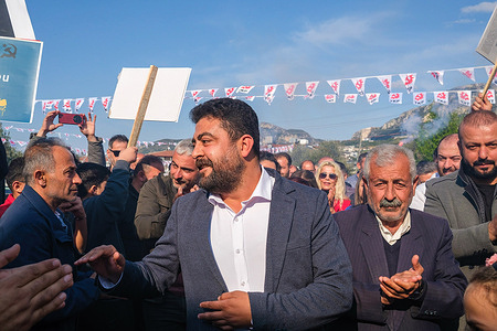 Hizam Hasirci greets his supporters during the rally. Communist Party of Turkey (TKP) Defne Mayor Candidate Hizam Hasirci organized a rally in Defne district of Hatay. Defne, the district of Hatay that suffered the most damage in the earthquake, plays a critical role in the elections. People in the district say that the election race is between the Republican People's Party (CHP) and the Communist Party of Turkey (TKP) and that Hizam Hasirci is in the lead.