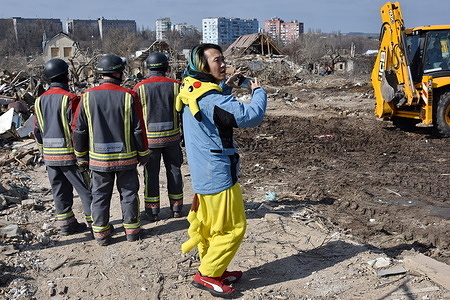 A Japanese volunteer (who arrived to help Ukrainians) stands by the rescuers at the scene of the private house destroyed following the Russian missile attack in Zaporizhzhia. Russia launched another large-scale drone and missile attack against Ukrainian cities overnight on March 22, targeting Kharkiv, Zaporizhzhia, and Kryvyi Rih, primarily aiming at the energy infrastructure. Attacks were also reported in Khmelnytskyi, Odesa, Mykolaiv, Vinnytsia, Kirovohrad, Lviv, Sumy, Poltava, and Ivano-Frankivsk oblasts. Russia launched 60 Shahed-type drones and almost 90 missiles of various types against Ukraine in the overnight strike, President Volodymyr Zelensky said.