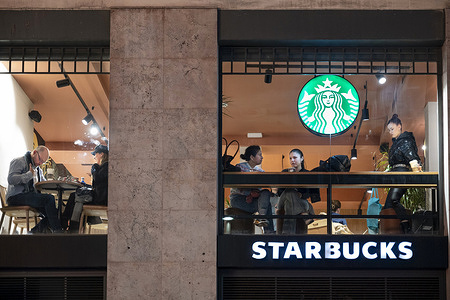 Customers are seen at the American multinational chain Starbucks Coffee store.