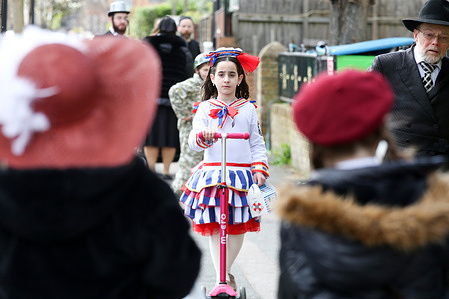 An Orthodox Jewish child dressed in a costume takes part in the annual festival of Purim on the streets of Stamford Hill in north London. Purim festival is celebrated by Jewish community around the world, commemorating it, when Jewish people were saved from Haman. It is a joyous annual festival where children dress in fancy costumes, friends and family, feast, rejoicing and exchanging food.