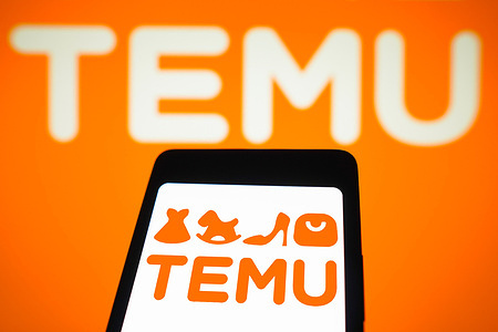 In this photo illustration, the Temu logo is displayed on a smartphone screen and in the background.