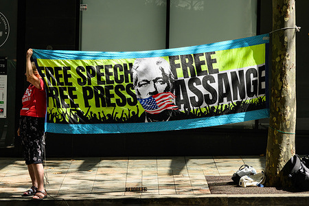 A banner depicting Julian Assange and says "Free speech, free press, free Assange" seen outside the US Consulate General. Protesters gathered outside the US Consulate General in Sydney to urge the US Government to stop the extradition of Julian Assange, the Australian journalist who founded WikiLeaks.