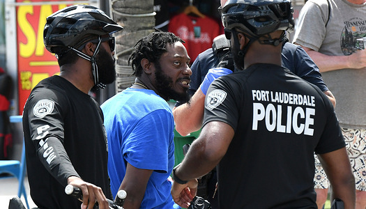 Fort Lauderdale Police take a man into custody as college students and others gather during spring break in Fort Lauderdale, Florida.