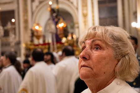 A woman is seen inside the Church of San Isidro, also known as the Collegiate Church of San Isidore, where the Gran Poder brotherhood and priests are conducting a mass on Holy Thursday, as the procession was suspended. Madrid experienced adverse weather conditions, including rain and wind, which forced the cancellation of Easter processions on Thursday. This decision was made to prevent injuries to penitents due to slippery floors, as well as to safeguard the priceless history and heritage carried by the brotherhoods.
