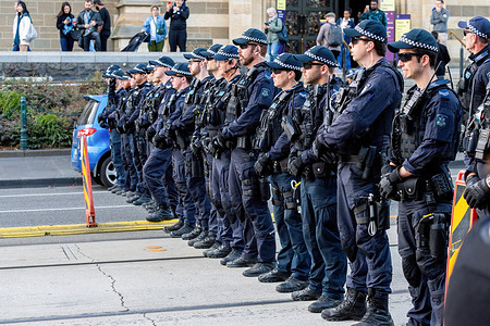 A line of Public Order Police on Flinders Street outside of St Paul's Cathedral seen during a snap and sit-in protest. In Melbourne, a peaceful protest unfolded calling for an end to the Israel-Palestine conflict. Despite a large police response, the event remained nonviolent. Only one arrest occurred, involving an individual attempting to disrupt the proceedings.