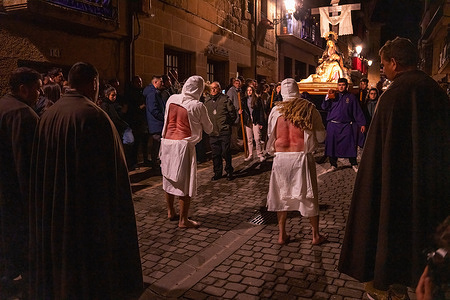 Devotees flog themselves with whips as they look at the image of the Virgin during the Good Friday "Los Picaos" procession in La Rioja. Hundreds of the faithful come to the church of San Vicente de la Sonsierra, in La Rioja, Spain during Good Friday to watch the procession of "Los Picaos".