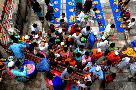 Large number of Muslim devotees seen gathered for their Iftar meal at the Nakhoda Mosque during the Holy month of Ramadan. Muslims around the world are required not to eat, drink and have sexual acts from dawn to dusk during the Holy Month of Ramadan.