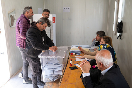 A voter casts his vote in a ballot box at a polling station during the 2024 Turkish local elections. Voting for the local elections on March 31, 2024 took place Antakya district of Hatay, an earthquake zone.