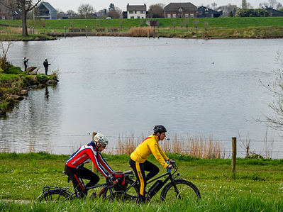 People are seen cycling while others are seen fishing in one of the canals. Despite the sun and rain fluctuations, the temperature was stable during the Easter weekend. Families and tourists took the chance to visit natural areas in the country, cycling along the dikes and forests, or going for a walk.