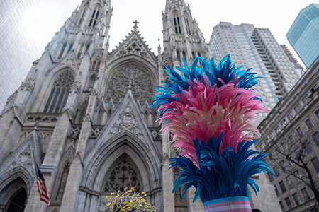 The top of a feathered hat in front of St. Patrisck's Cathedral New York’s Easter Parade and Bonnet Festival dates back to the 1870s. An Anual event, New Yorkers don colorful and creative Easter outfits to show off in front of St Patrick’s Cathedral on Fifth Avenue.