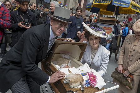 NEW YORK, NEW YORK - MARCH 31: (L-R) Matthew Karl Gale and Michelle Coursey dress in period costumes pose with month old son James and dog Lady Cookie at the Easter Parade and Bonnet Festival 2024 outside St. Patrick's Cathedral along Fifth Avenue on Easter Sunday, March 31, 2024 in New York City.