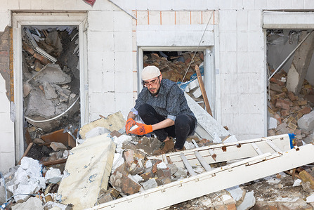 A man is seen removing debris after a rocket attack destroyed the Academy of Decorative and Applied Arts building. A part of the building of the Mykhaylo Boychuk Academy of Decorative and Applied Arts and Design was damaged as a result of a missile strike on 25 March in the Ukrainian capital. The central part of the building was damaged. As a result, the sports hall, conference hall and exhibition centre were completely destroyed. The premises of the departments and classrooms of the educational institution were also significantly damaged.