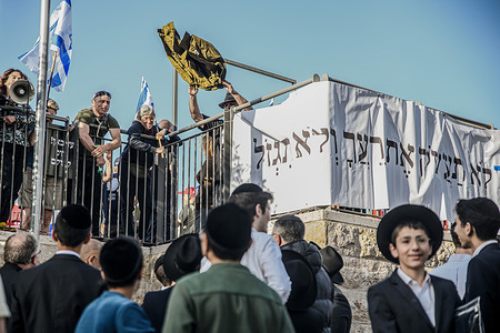 Israeli protesting reservists hold up Israel Defense Forces (IDF) uniforms in front of orthodox youth in a demand for equal army enlisting. Israeli protesters calling for immediate general elections, a hostage deal, and orthodox recruitment for the Israel Defense Forces (IDF) demonstrated in front of the house of Aryeh Deri, chairman of the Haredi Shas party.