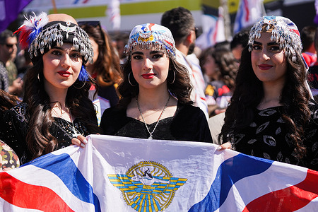 Assyrians young women dressed traditional clothes pose for a picture during the celebration of Assyrian New Year 6774 in Dohuk.