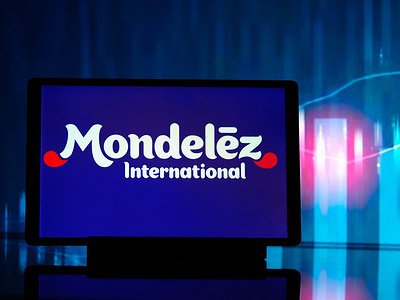 In this photo illustration, a Mondelez International, Inc. logo seen displayed on a tablet.