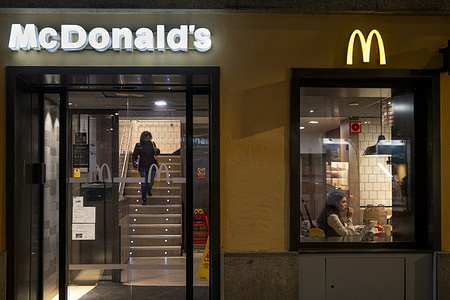 People are seen at the American multinational fast-food hamburger restaurant chain, McDonald's.