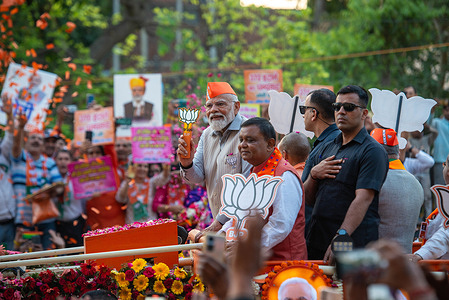 India's Prime Minister, Narendra Modi (C), holding the party symbol aloft from atop a vehicle during the roadshow campaign. The Indian general elections scheduled to take place from 19th April 2024 to 1st June 2024, aiming to elect the 543 members for the 18th Lok Sabha.