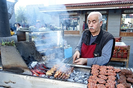 A mobile kebab seller in Diyarbakir is seen roasting kebab varieties and meatballs over the fire. In Diyarbakir, the historical city of Turkey, there is shopping excitement before Eid al-Fitr.
