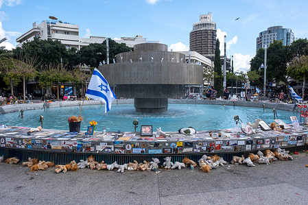 Photos, flowers and other memorial items surround the fountain in Dizengoff Square. The fountain at Dizengoff Square has become one of the locations in Tel Aviv for people to create makeshift memorials for those killed and kidnapped during the October 7th, 2023 attack by Hamas.